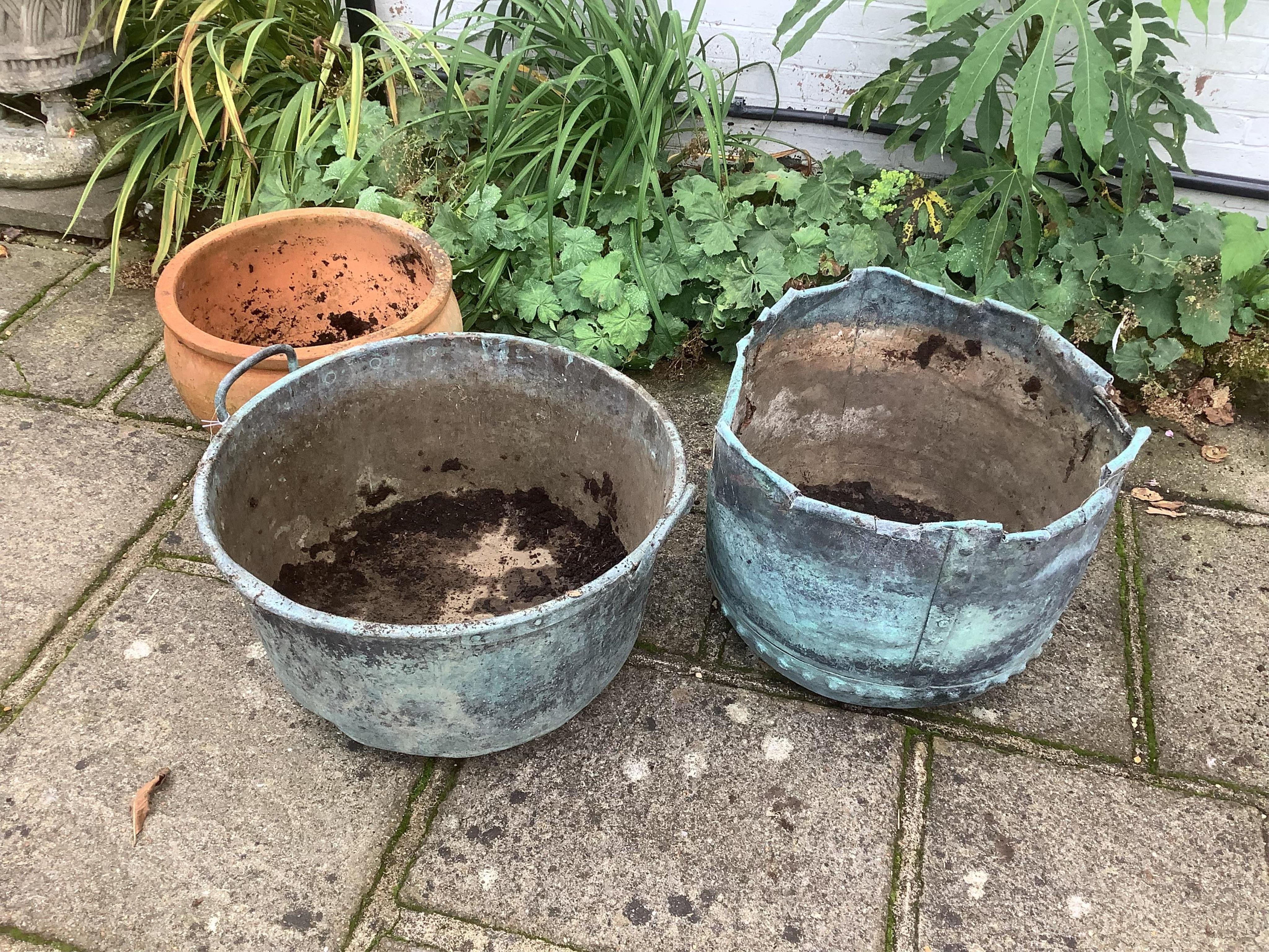 Two copper planters and one terracotta planter, planting removed, largest height 46cm. Condition - all weathered, copper copper - rim petalled